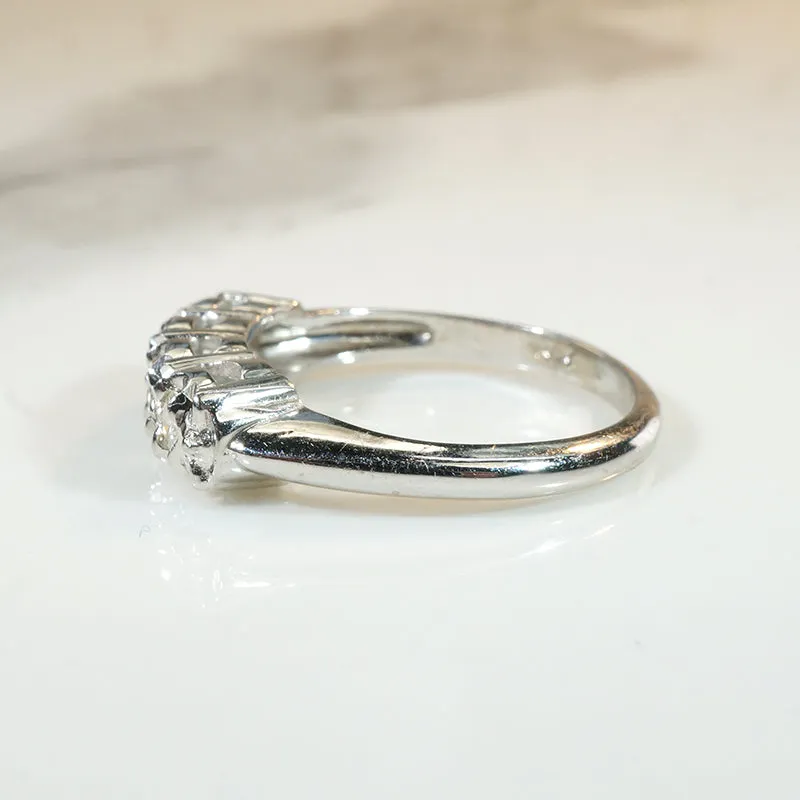 Four Sparkling Diamonds in Curvy White Gold Band